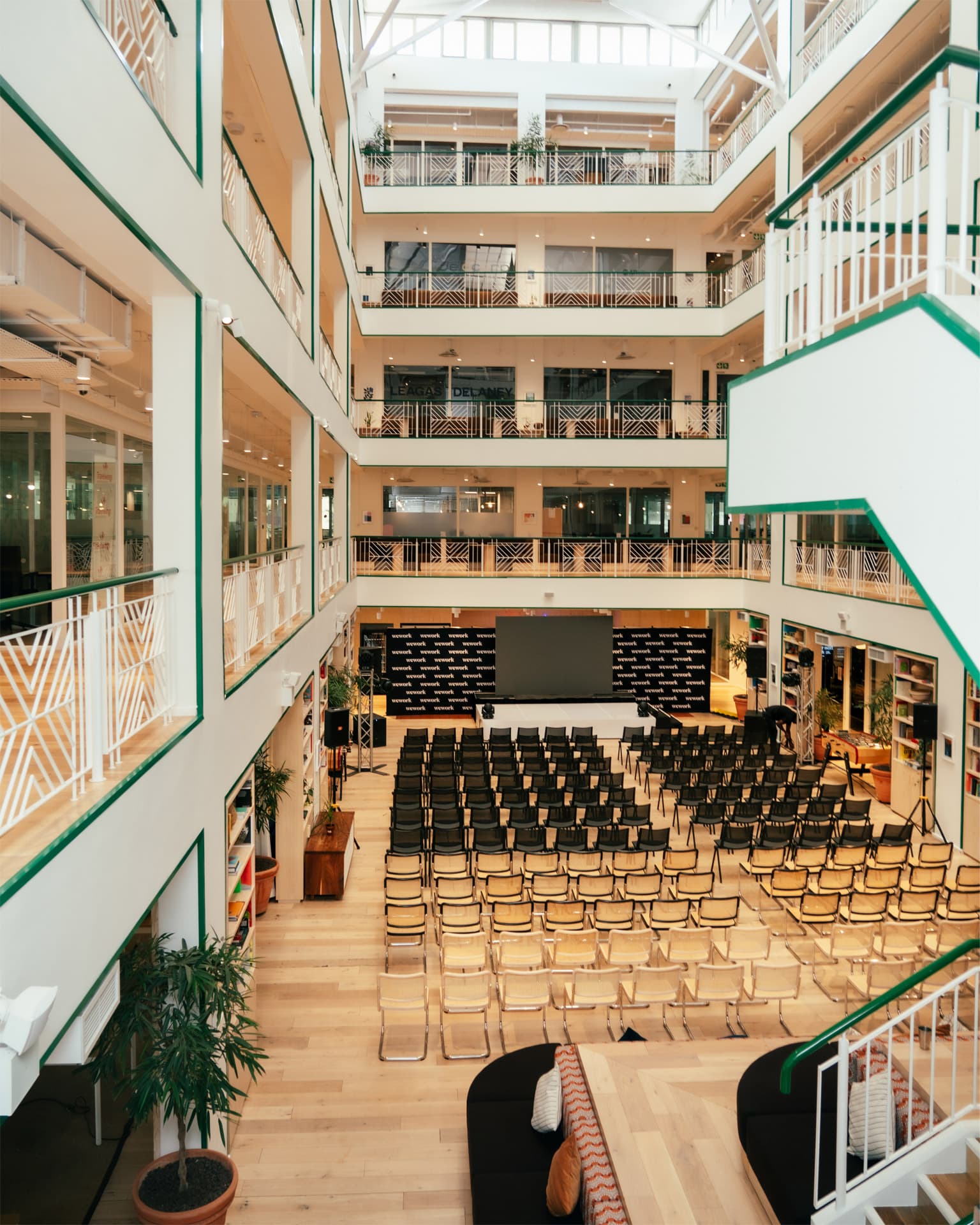 View of the event space when standing on the balcony, includes chairs and a presentation screen